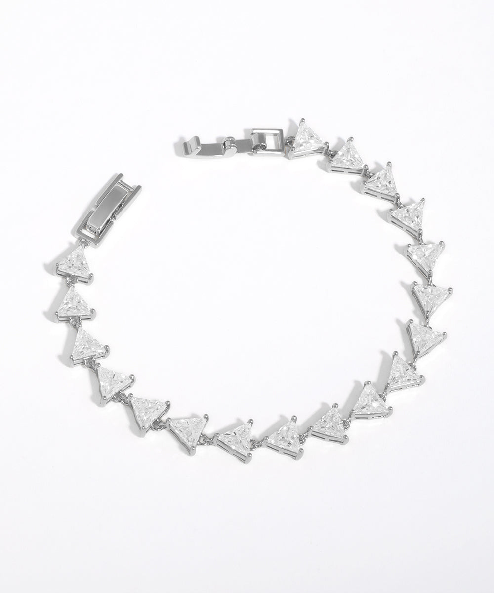 Silver bracelet with triangle-shaped crystals on a white background