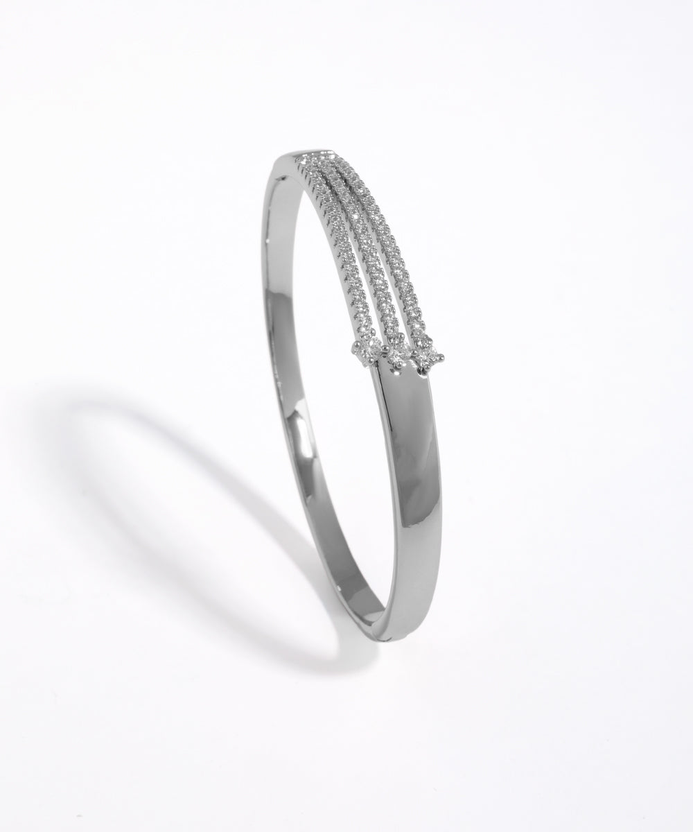 Silver bangle with small stones on a white background
