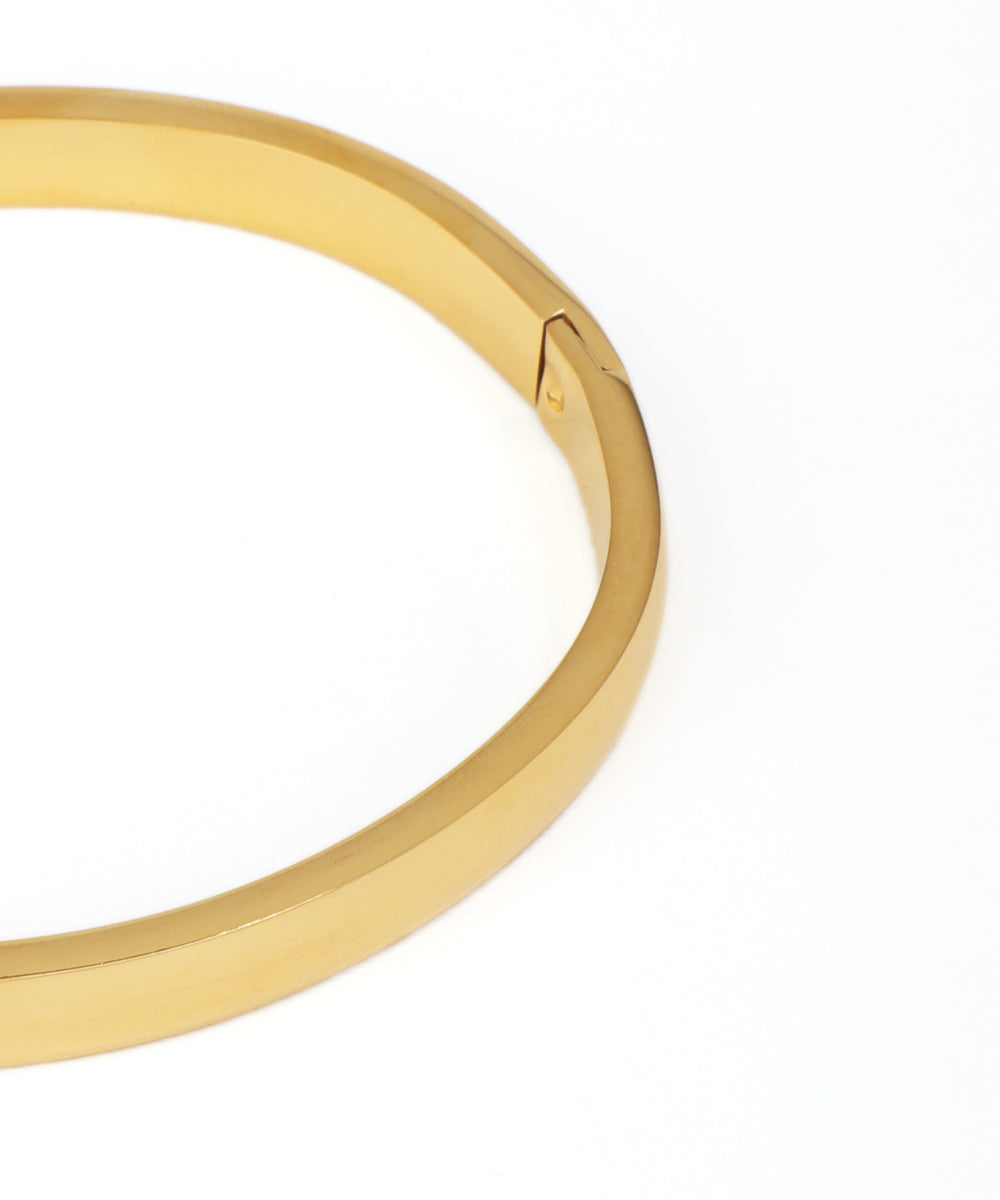 Gold bangle on a white background