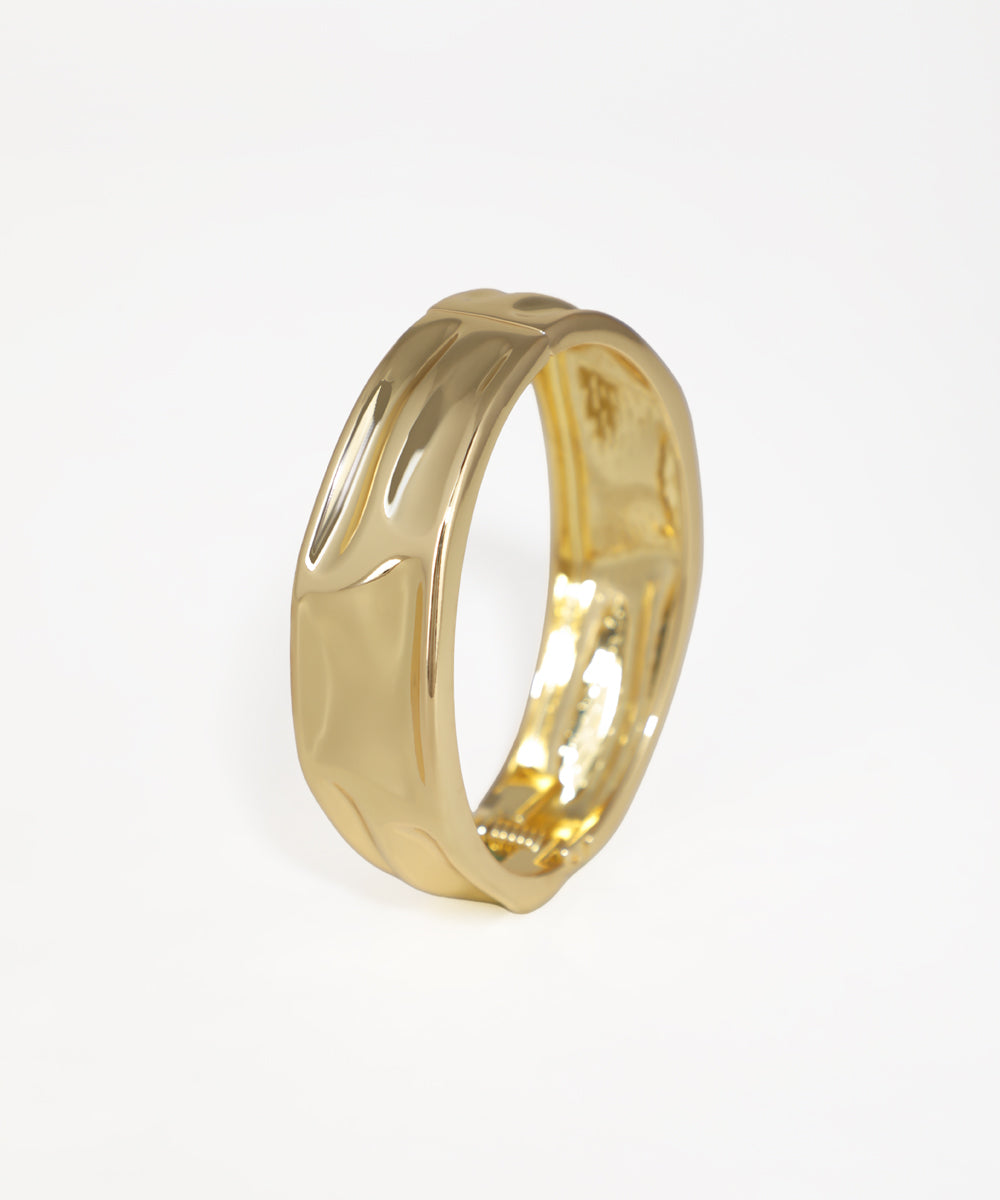 Gold-tone bangle kada with a wide, curved surface design