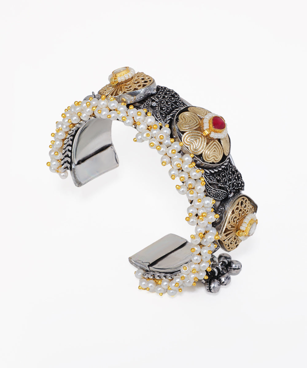 Decorative bracelet with floral designs and beads on a white background