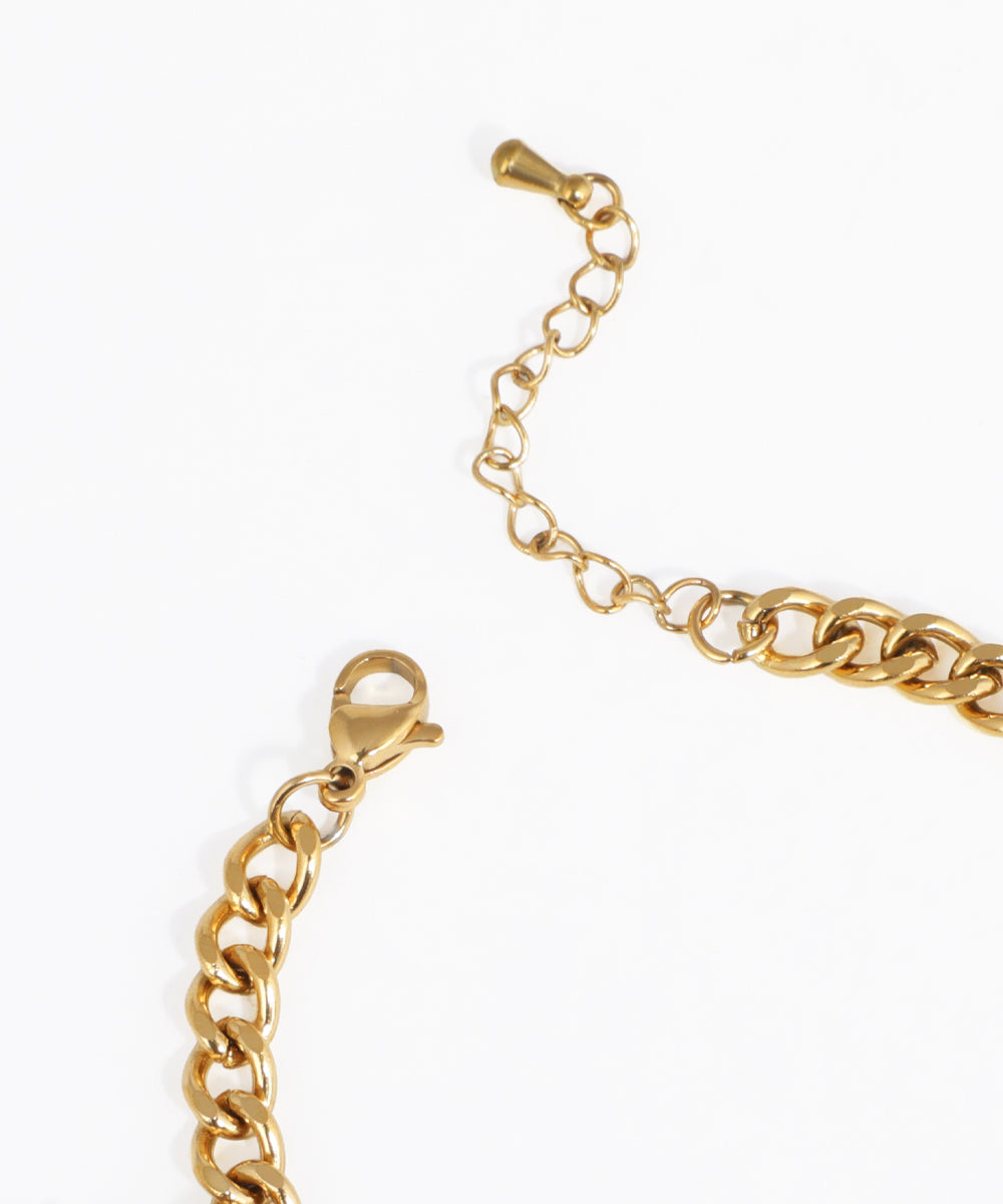 Gold chain bracelet on a white background