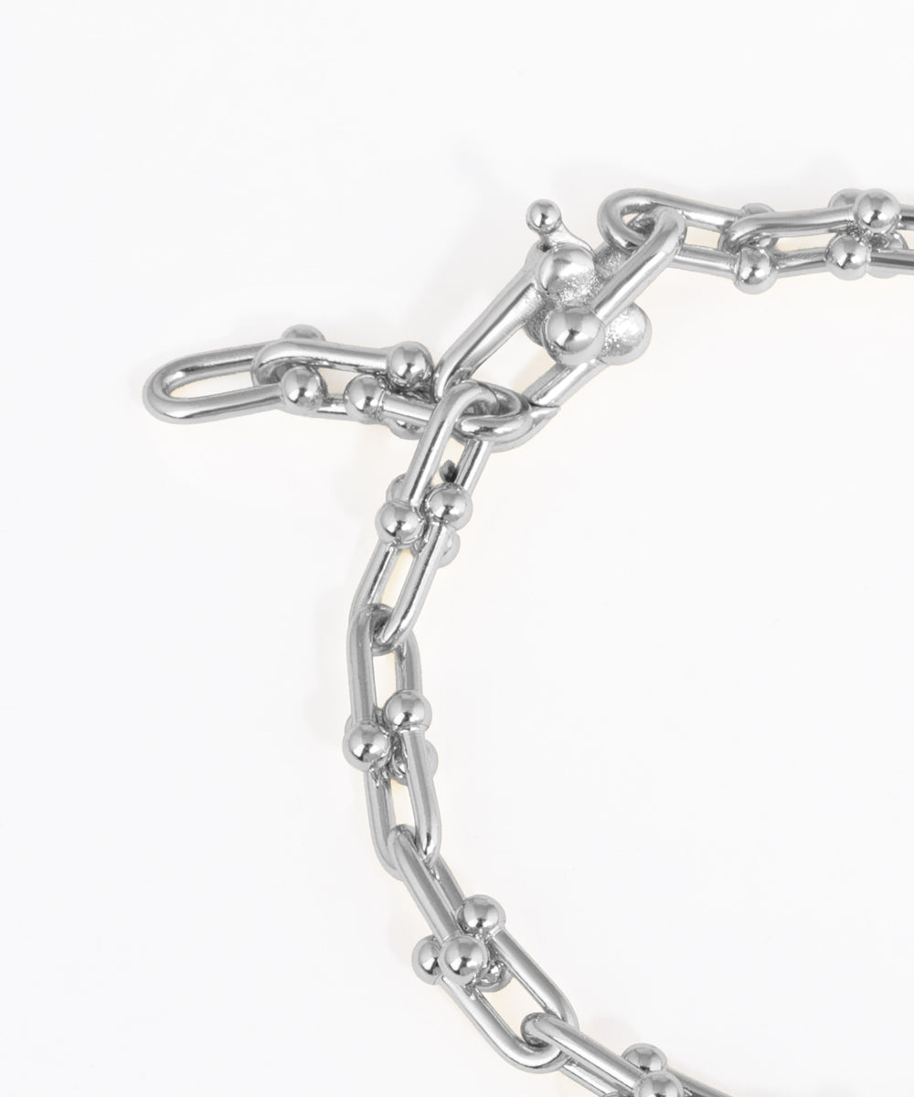 Close-up of a silver chain bracelet on a white background