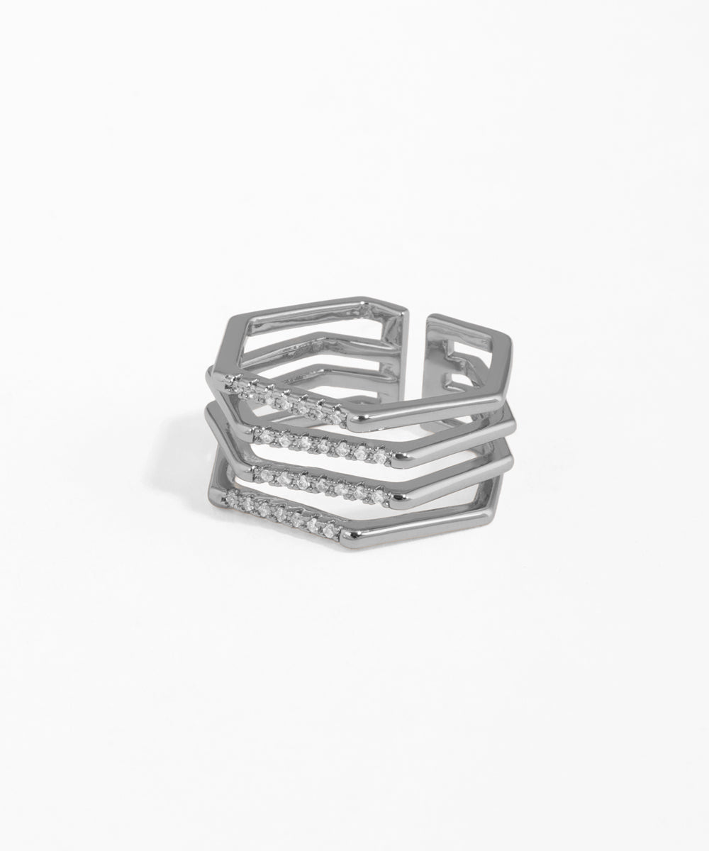 Stack of silver rings with geometric design on a white background