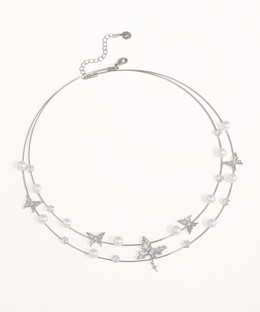 Rhodium finish necklace with faux pearls, CZ stones, and butterfly motifs on a double strand design.