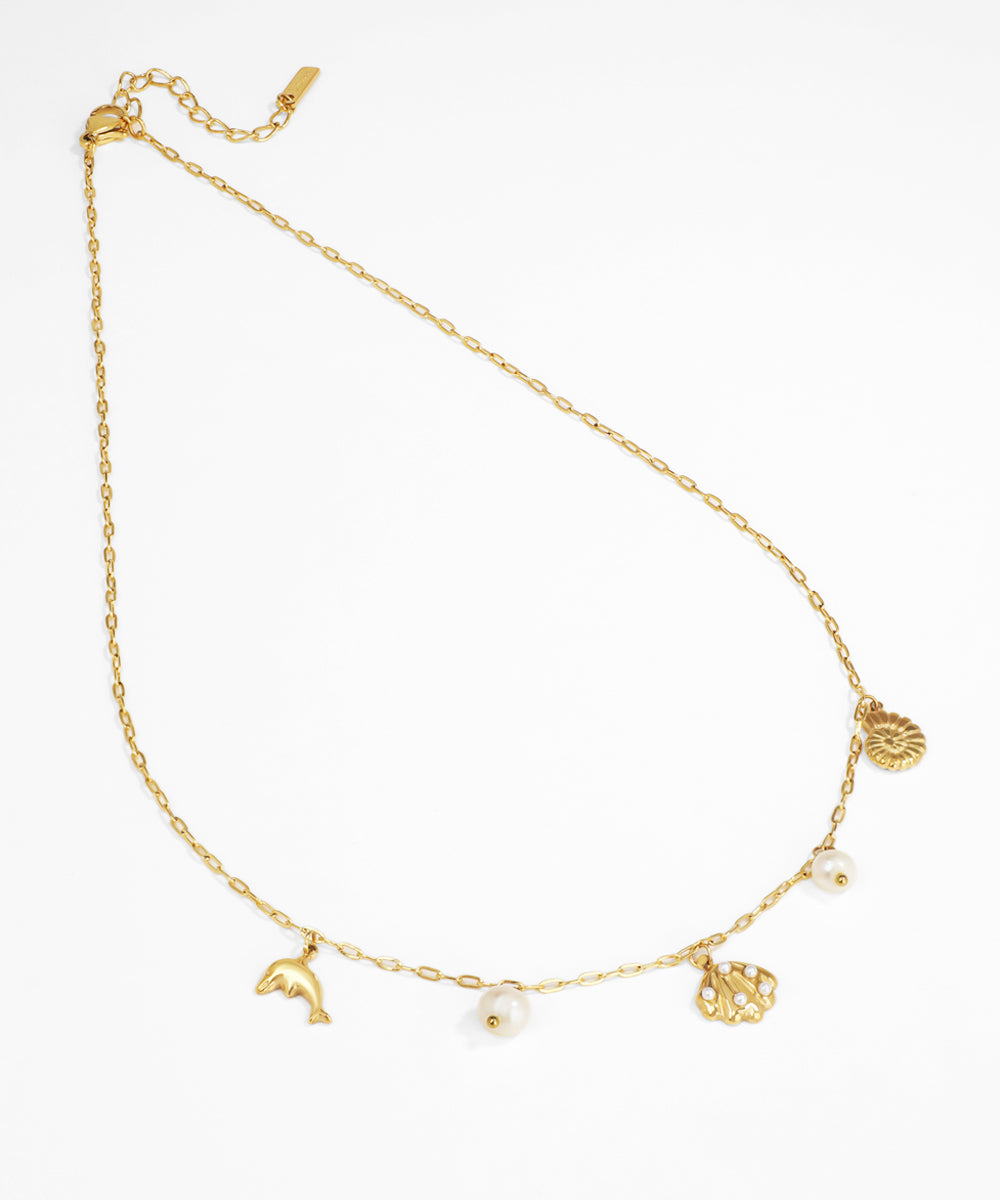 Gold anklet with various charms on a white background