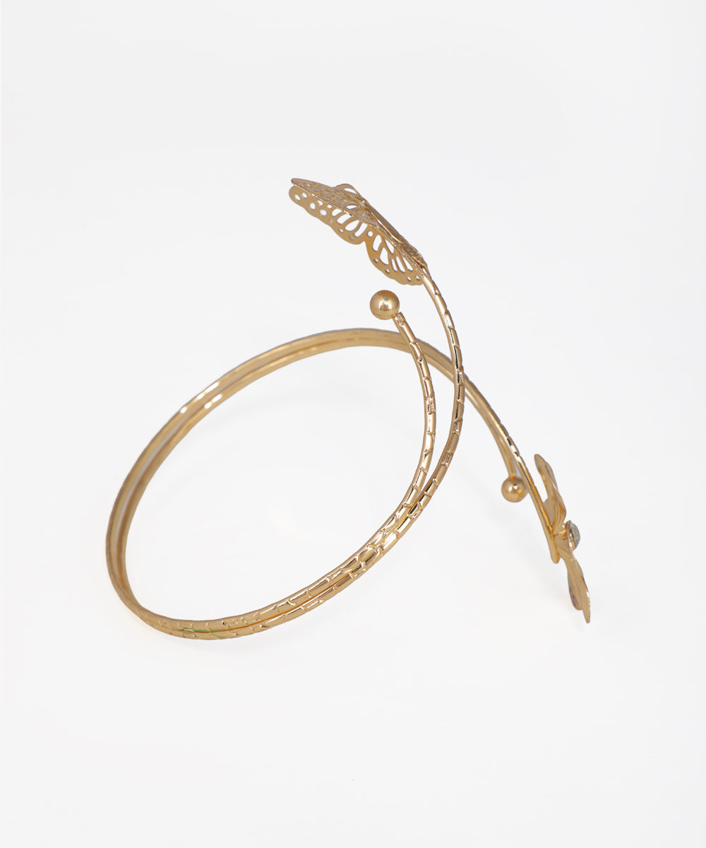 Gold bracelet with leaf designs on a white background