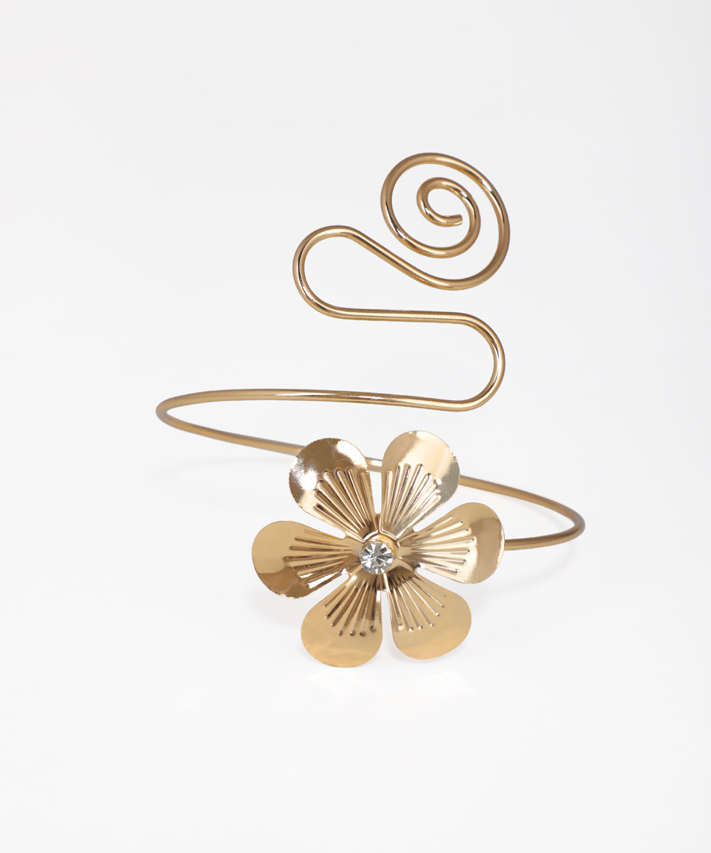 Gold bracelet with a floral design on a white background