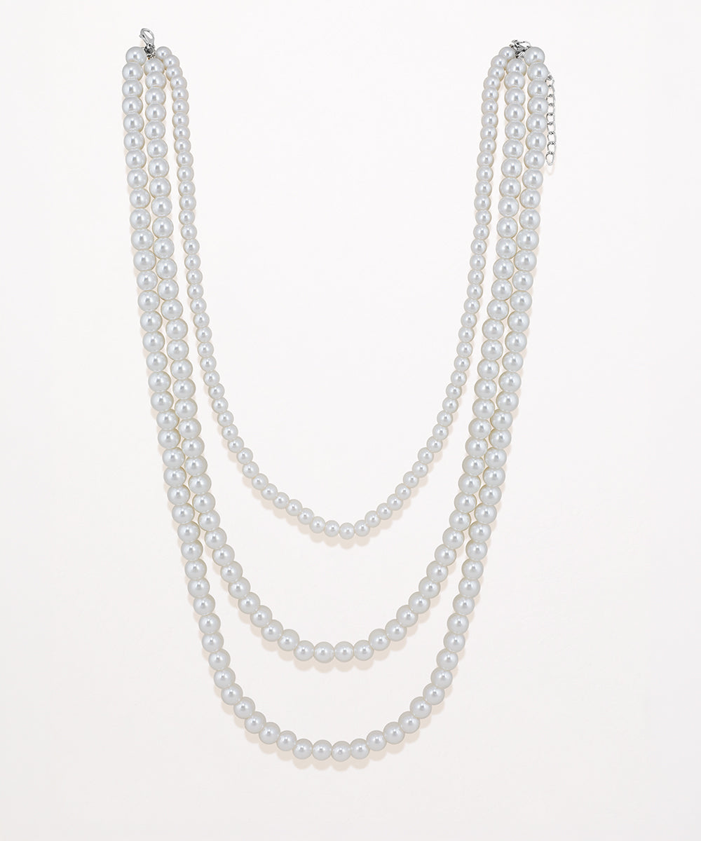 Silver-tone layered necklace with three strands of round faux pearls.