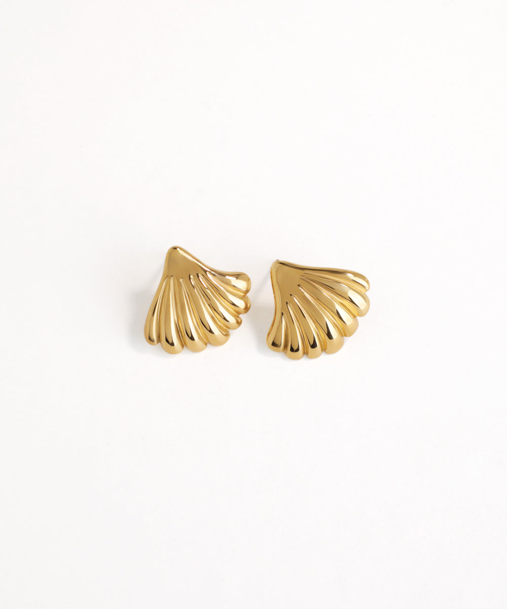 Gold shell-shaped earrings on a white background