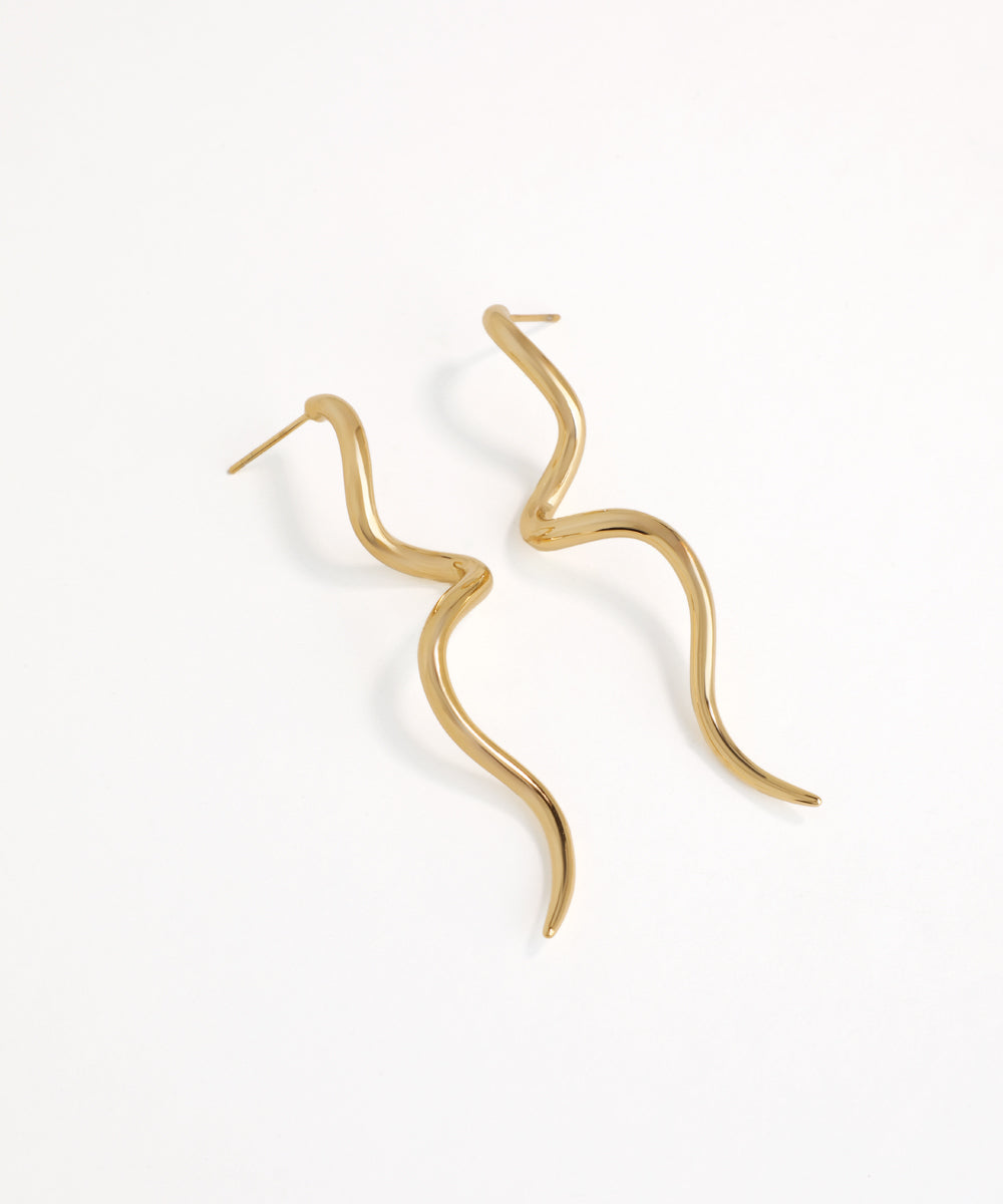 Gold hoop earrings wavy curvy on a white background