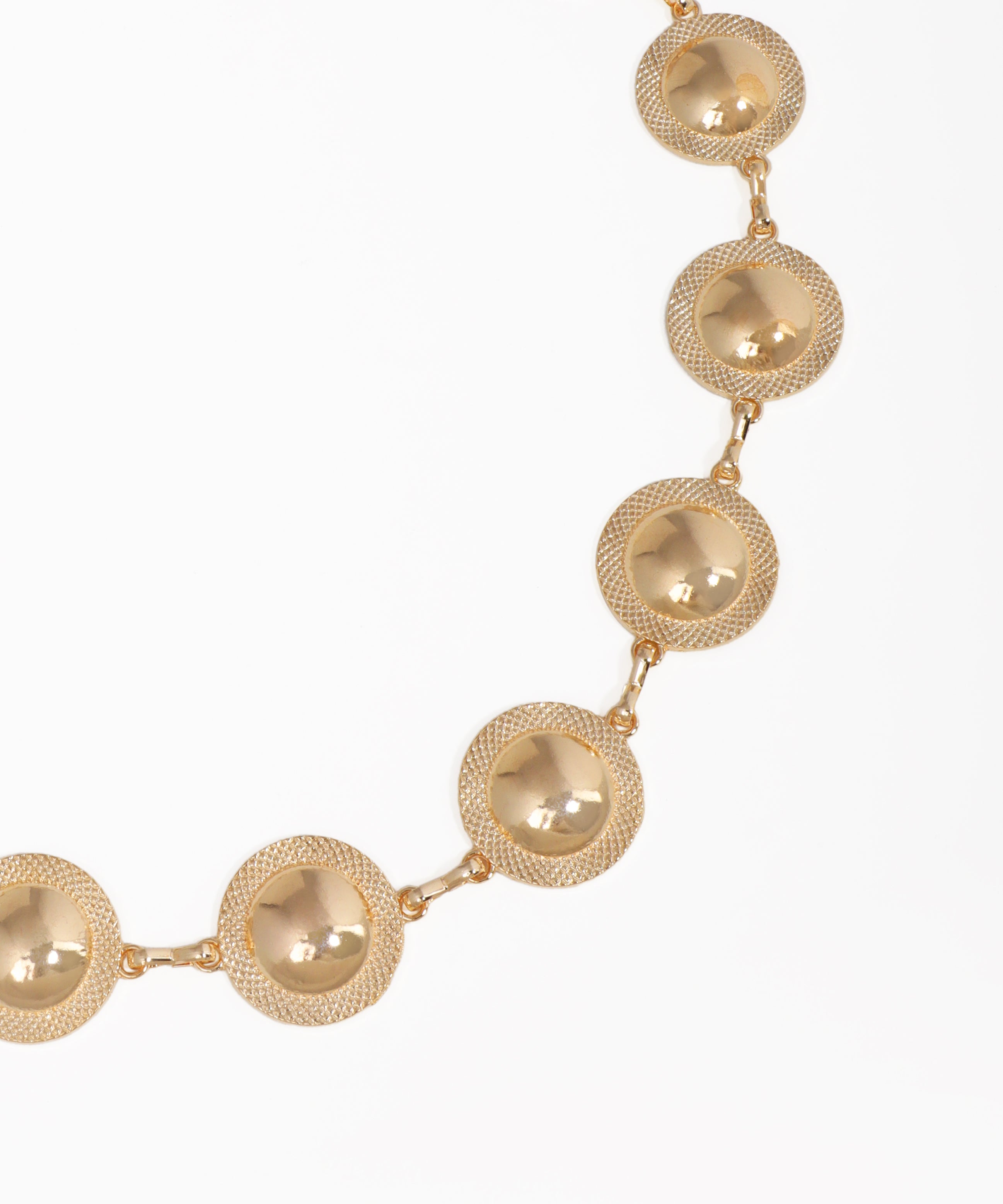 Gold necklace with round links on a white background