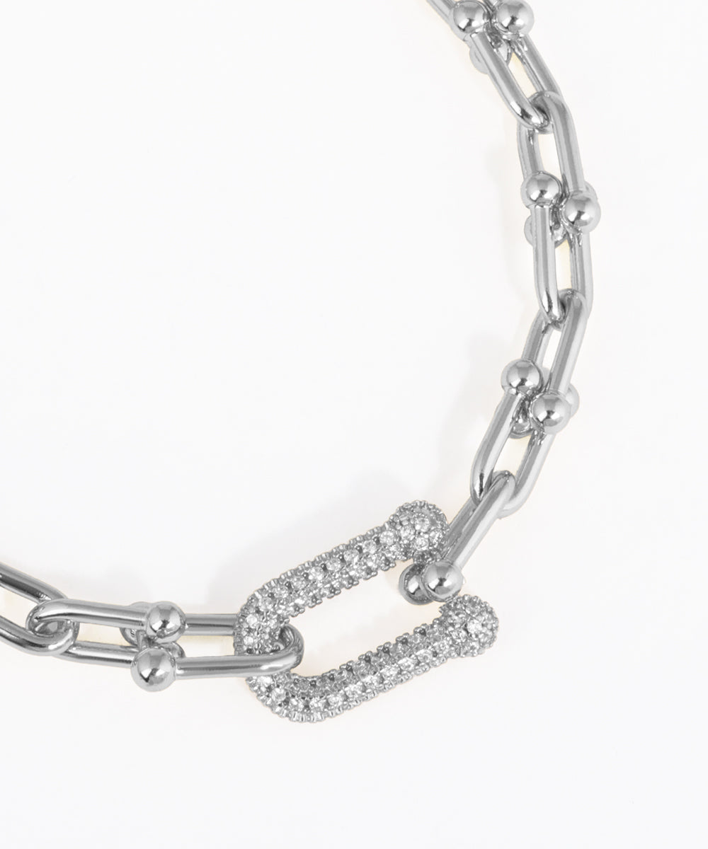 Silver chain bracelet with diamond accents on a white background