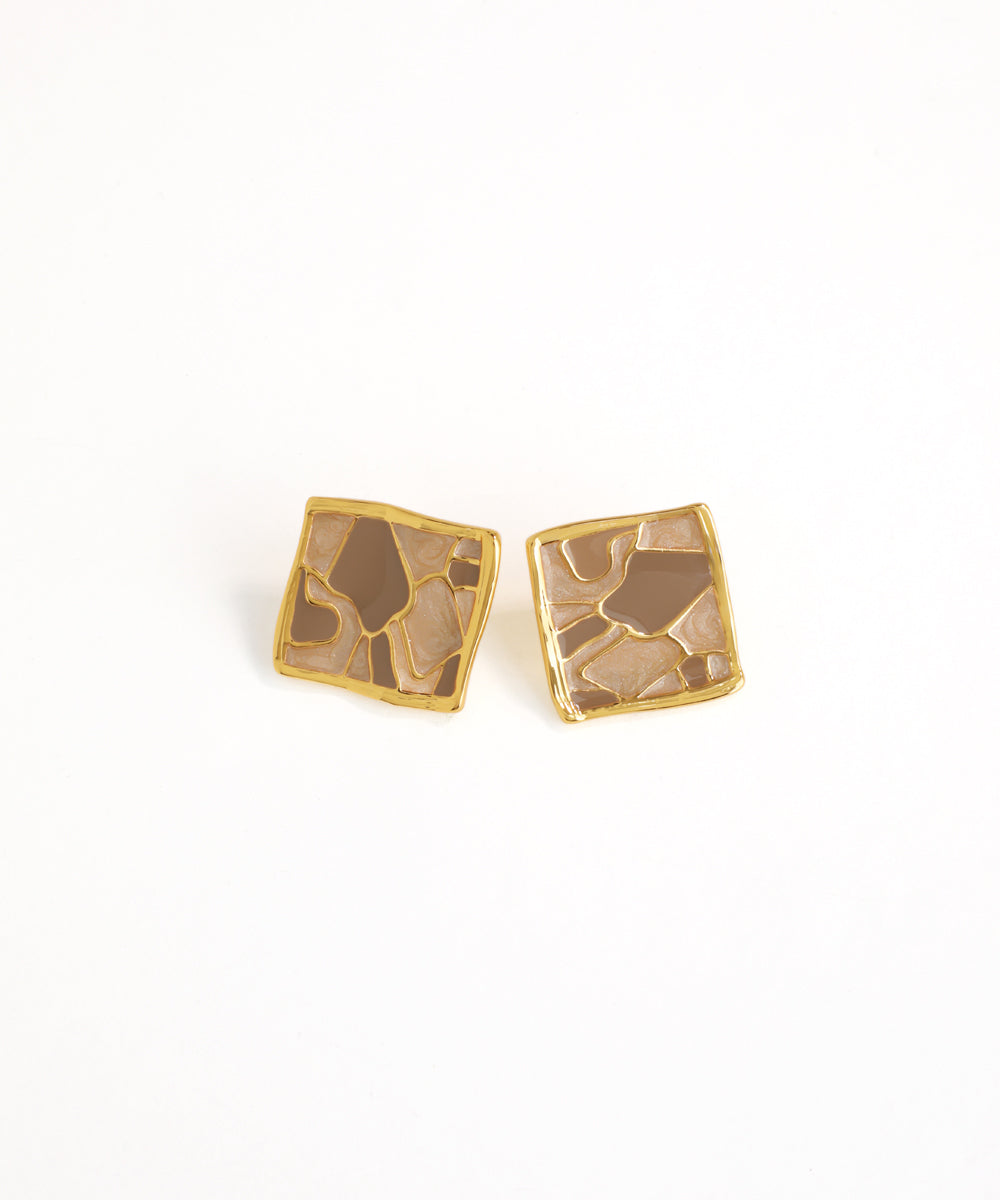Square-shaped earrings with gold frame and brown center on a white background