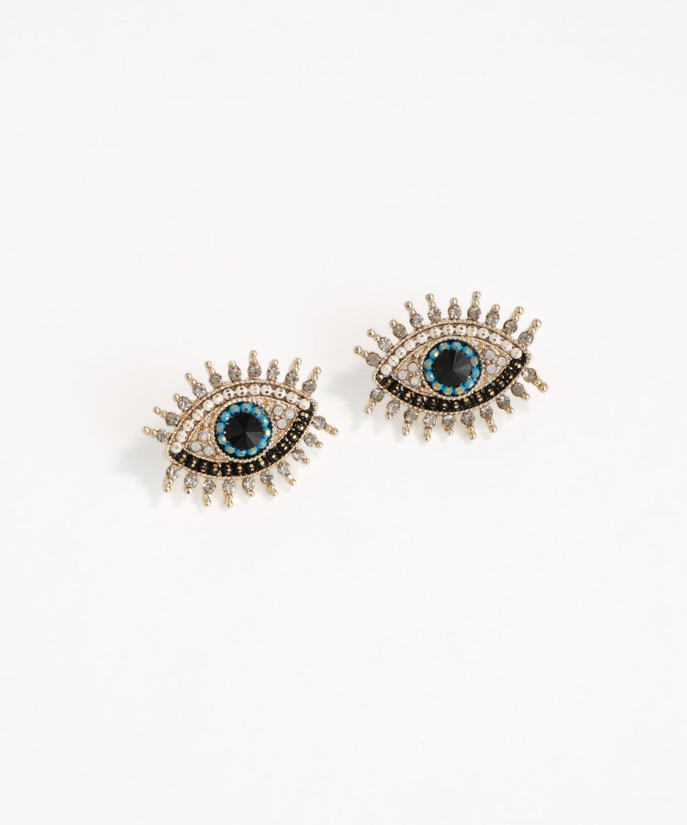 Pair of eye-shaped earrings with blue gemstones on a white background