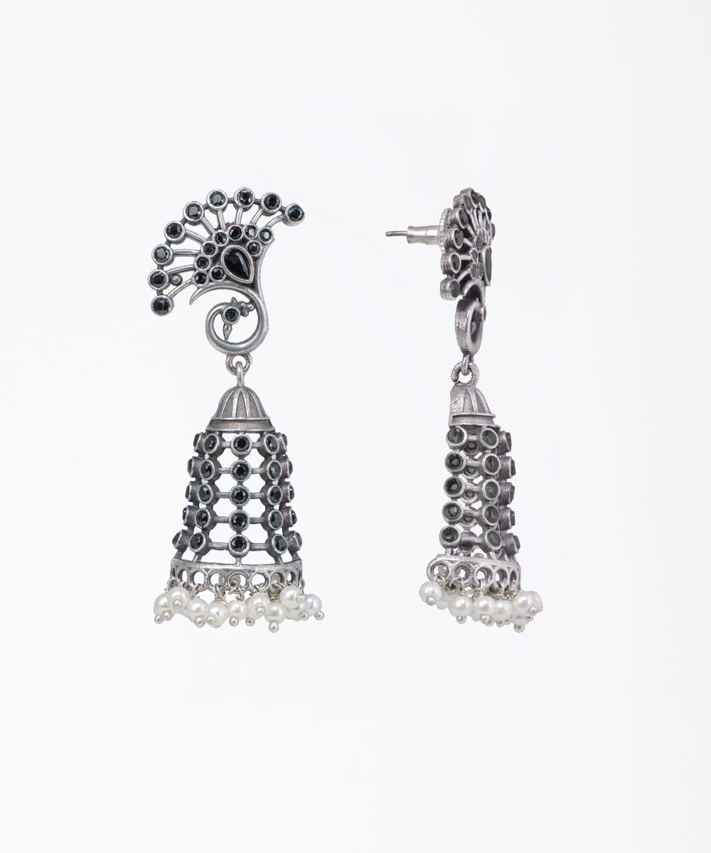 Silver jhumka earrings with black stones on a white background