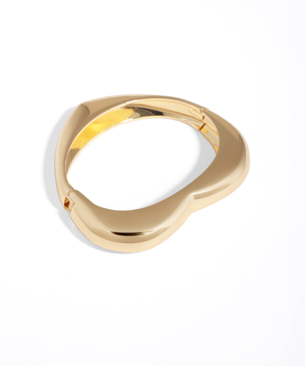 Gold ring with a unique design on a white background
