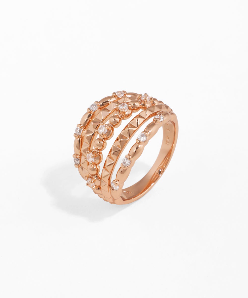 Rose-gold-tone ring with layered bands, studded texture, and sparkling Cubic Zirconia stones.