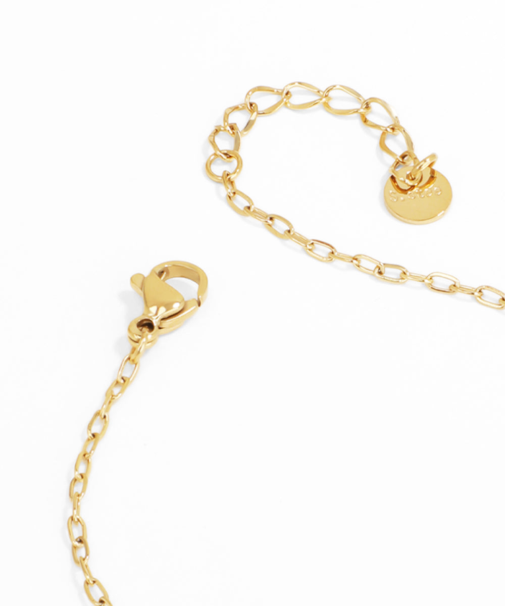 Gold chain bracelet with a heart lock clasp on a white background