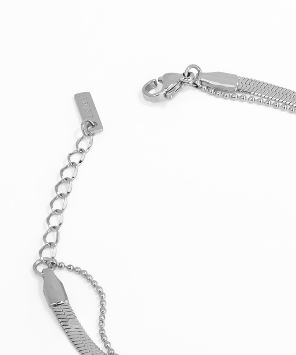 Close-up of a silver bracelet with chain extension on a white background