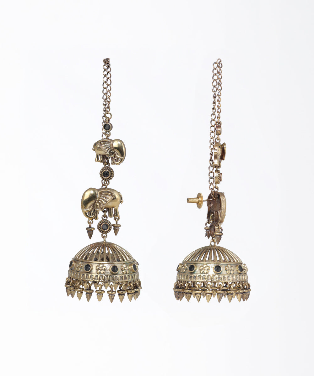 Pair of ornate gold earrings with intricate designs on a white background