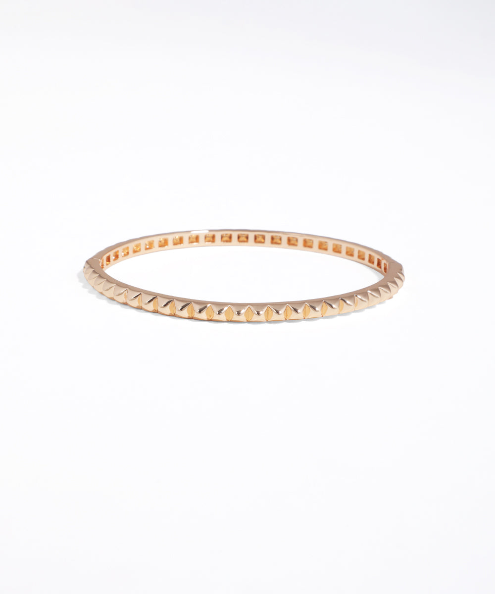 Rose gold bangle on a white background