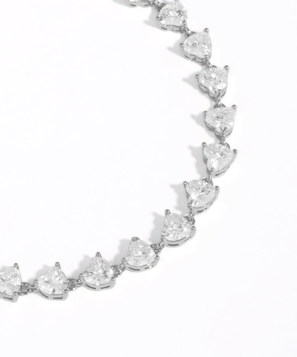 Silver bracelet with teardrop-shaped crystals on a white background