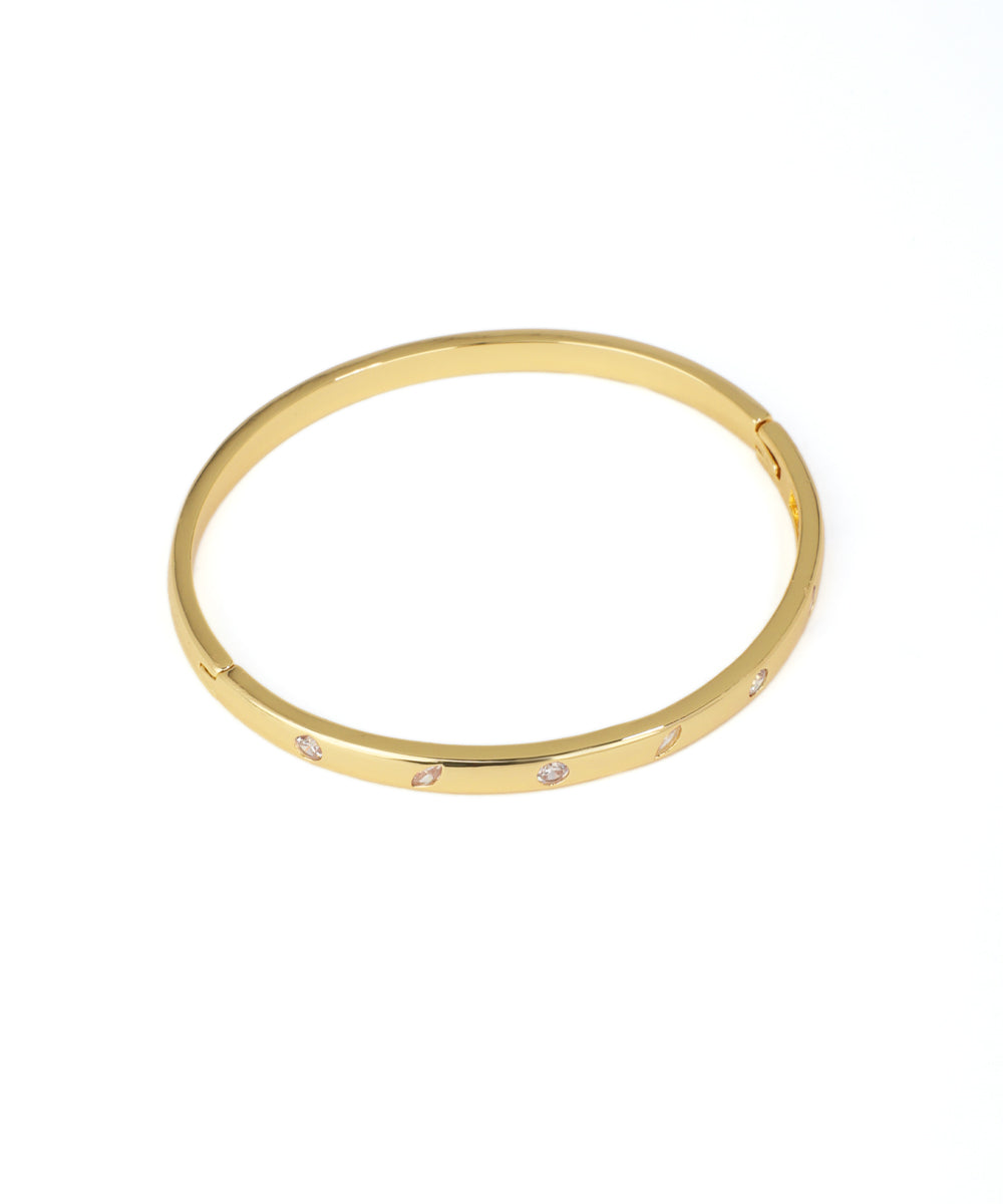 Gold bracelet with small diamonds on a white background