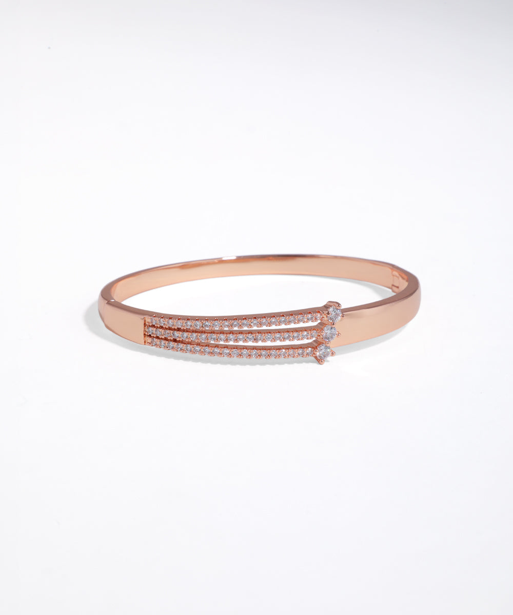 Rose gold bracelet with clear stones on a white background