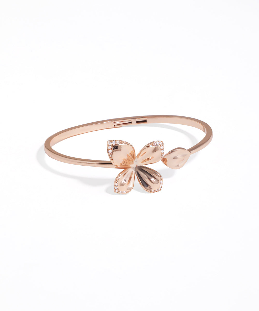 Rose gold bracelet with butterfly charms on a white background