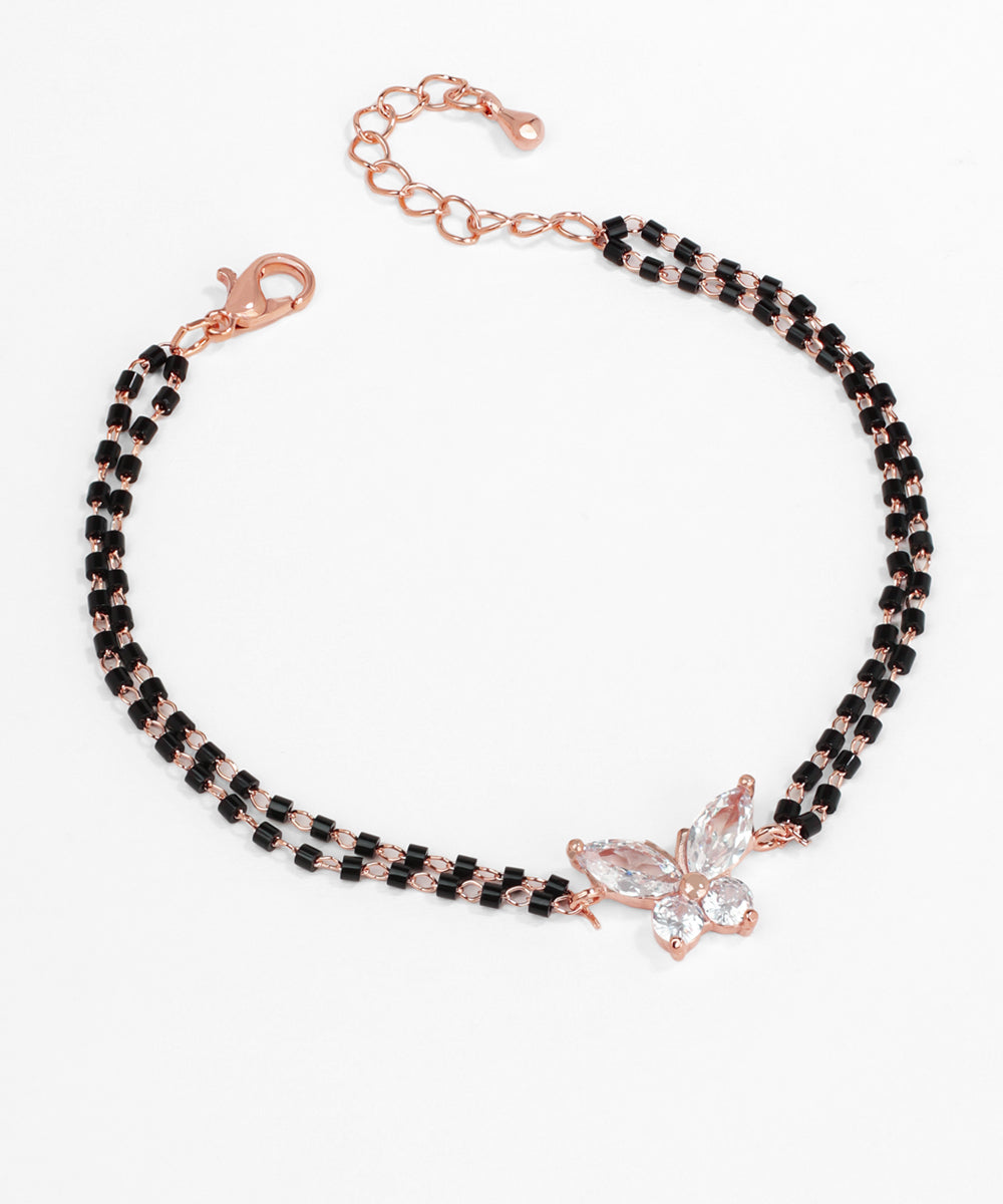 Necklace with black beads and rose gold butterfly clasp on a white background