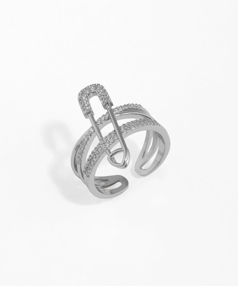 Silver ring with intricate design on a white background