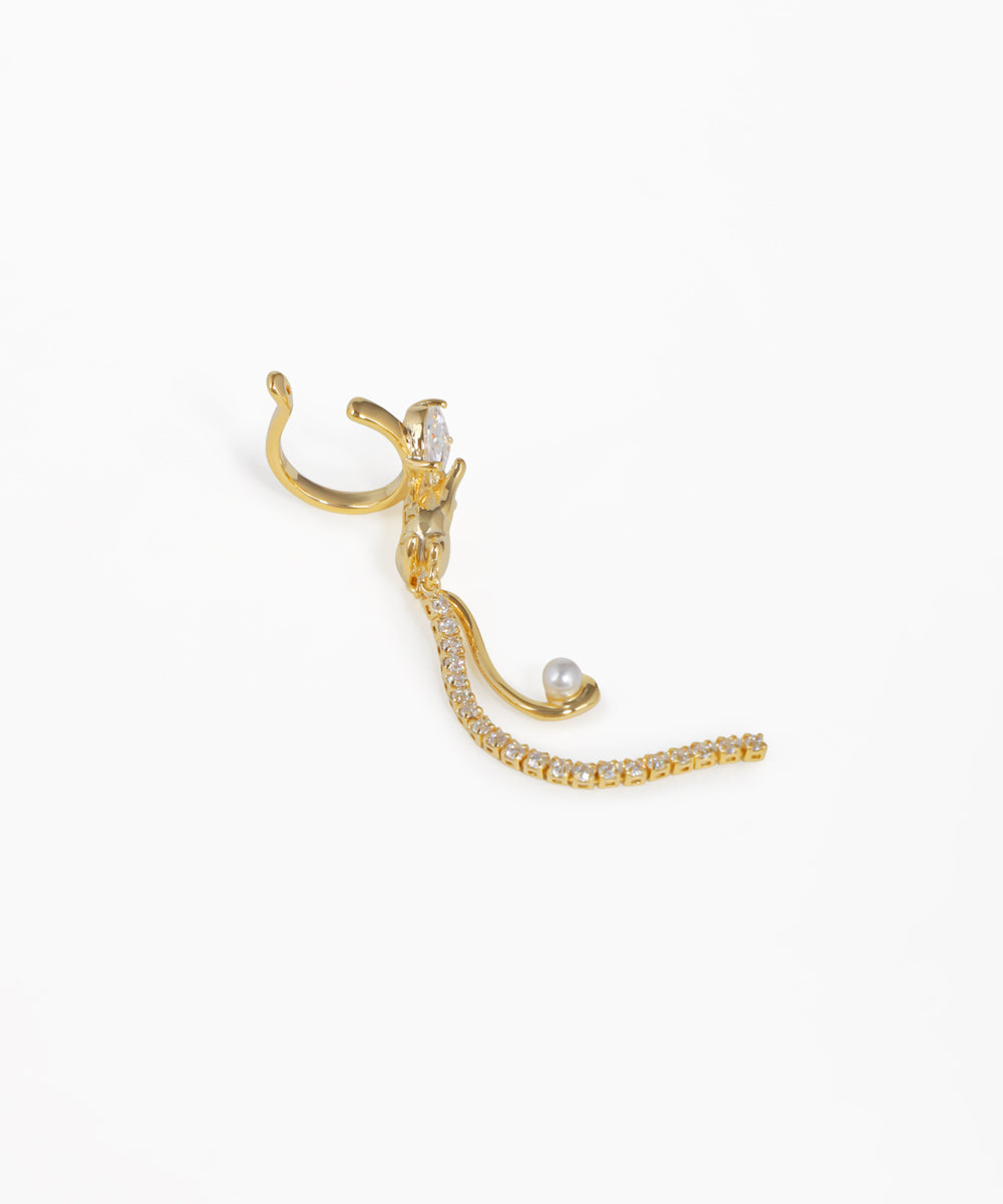 Gold ear cuff with pearls on a white background