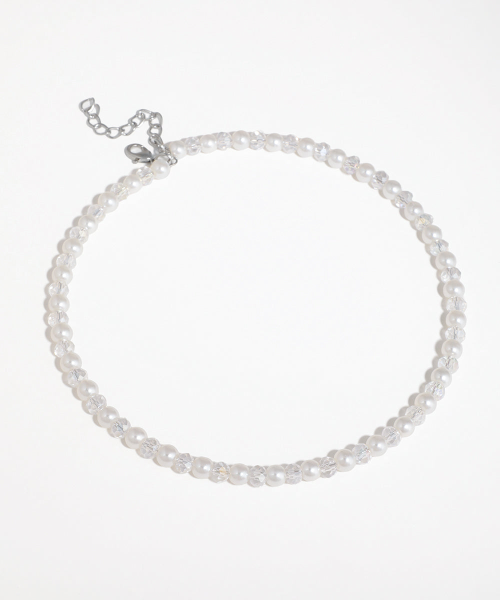 Silver-tone necklace with alternating white faux pearls and clear faceted glass crystals
