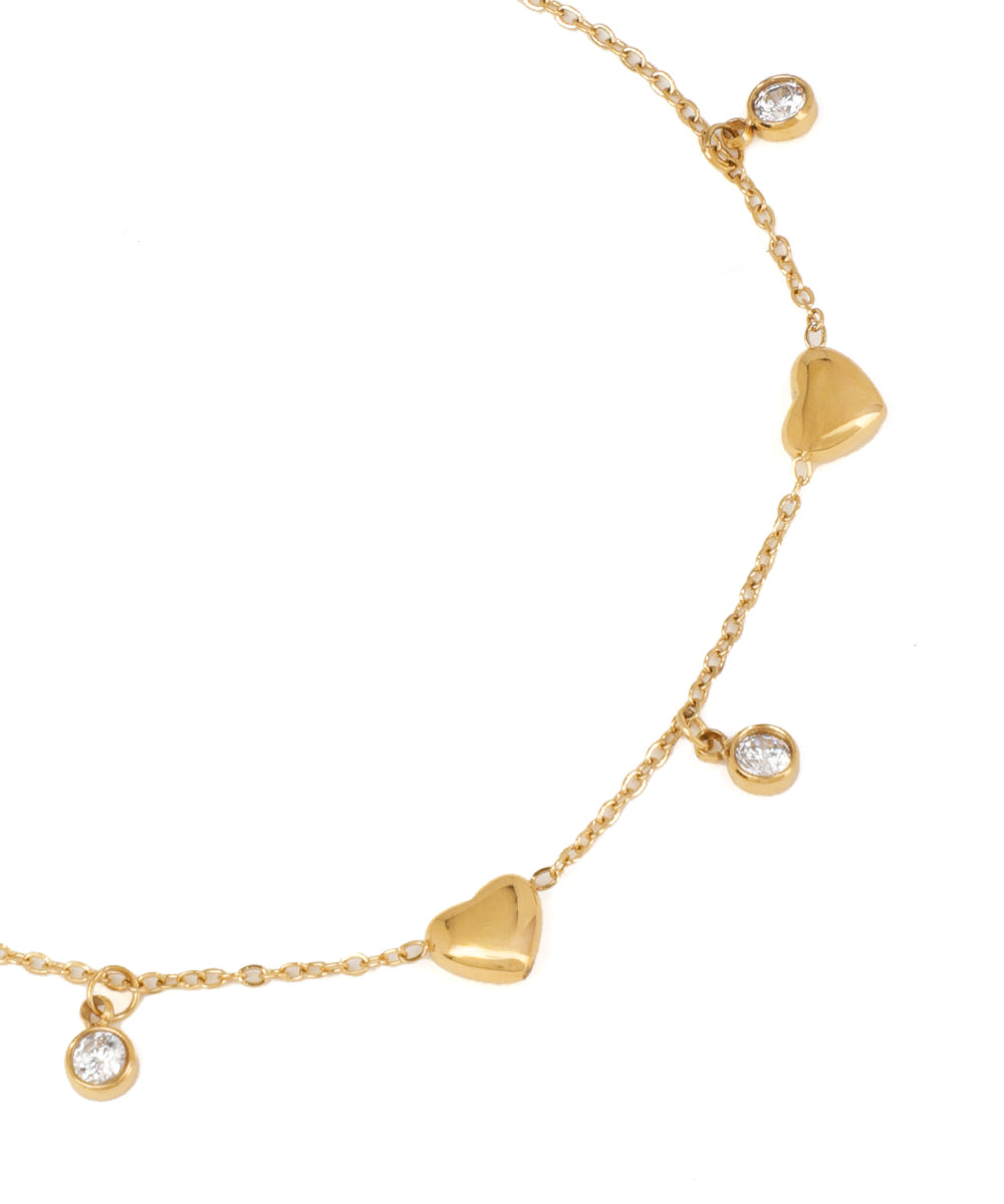 Gold necklace with heart-shaped pendants on a white background