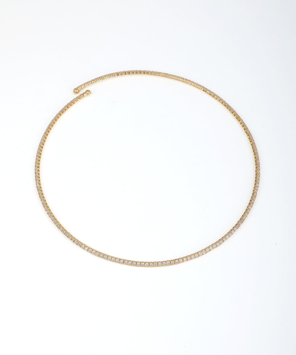 Gold-tone necklace with continuous line of small clear stones in a pave-style setting, open at the back.