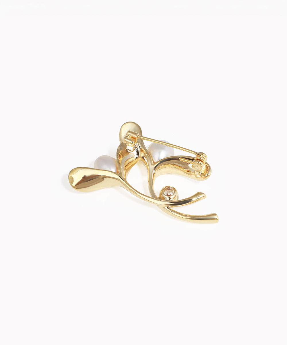 Gold earring with a pearl on a white background