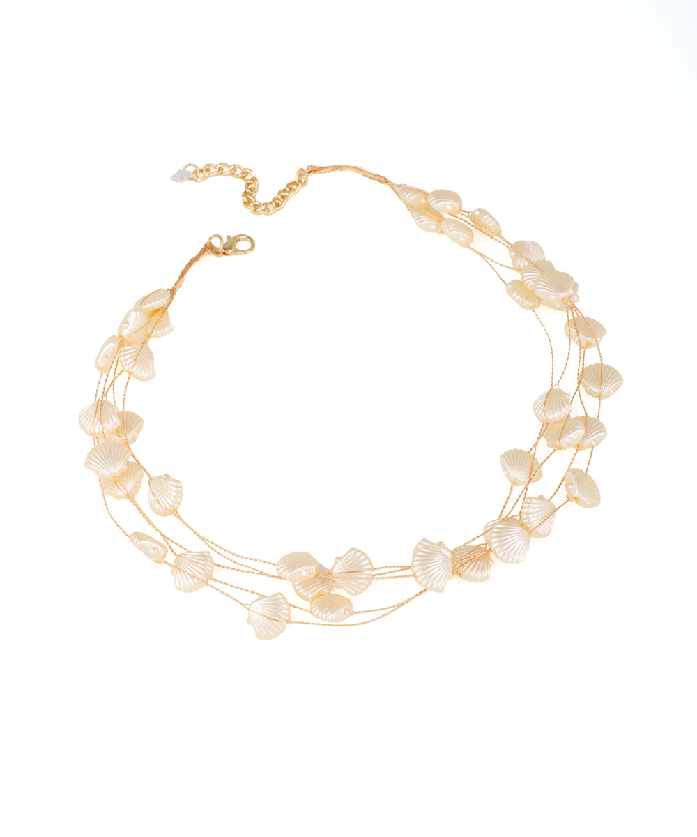Gold-tone necklace with tiered faux shell and faux pearl beads in a scallop petal design