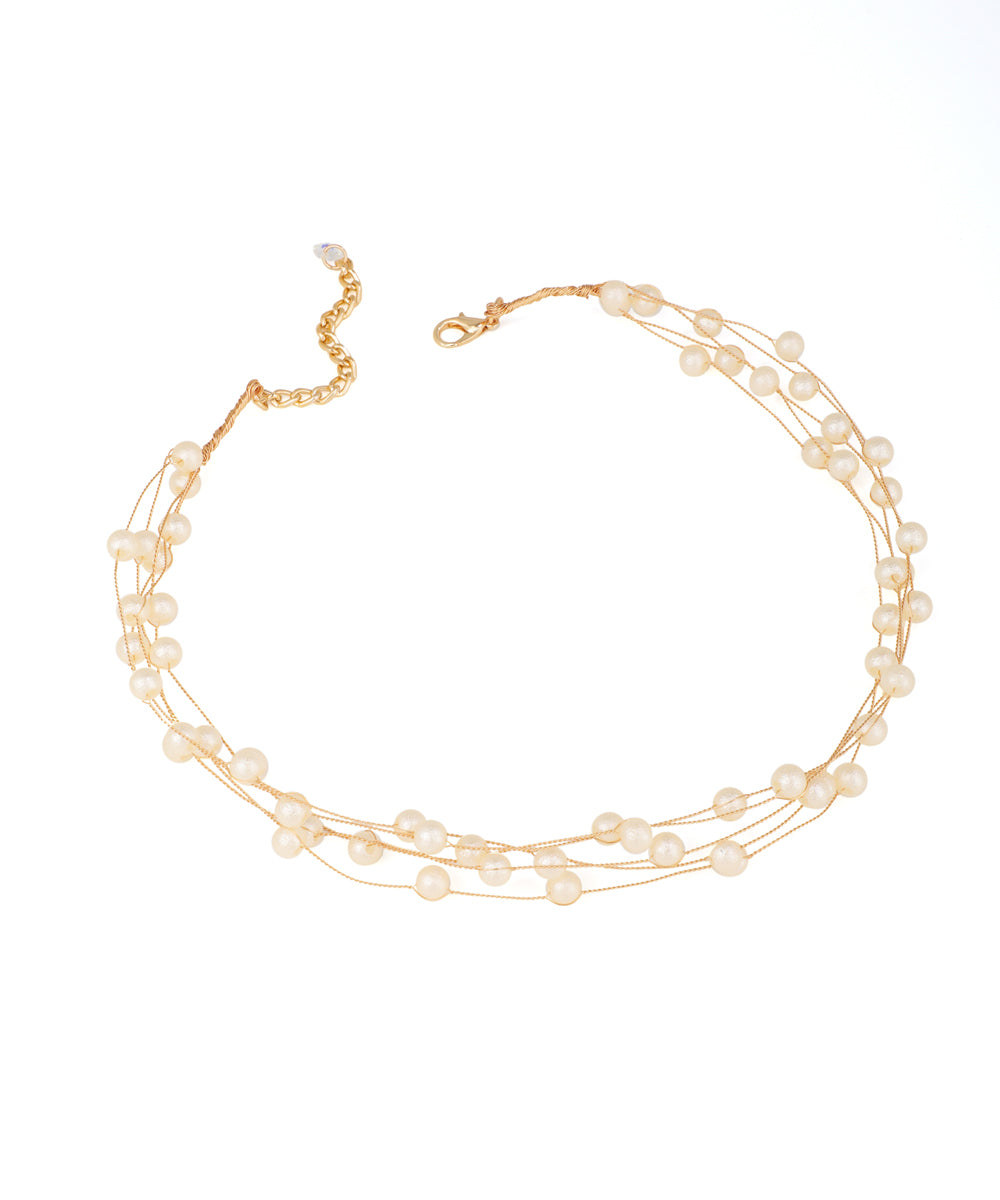 Gold-tone necklace with multiple delicate strands and uniformly spaced faux pearls, featuring an adjustable chain.