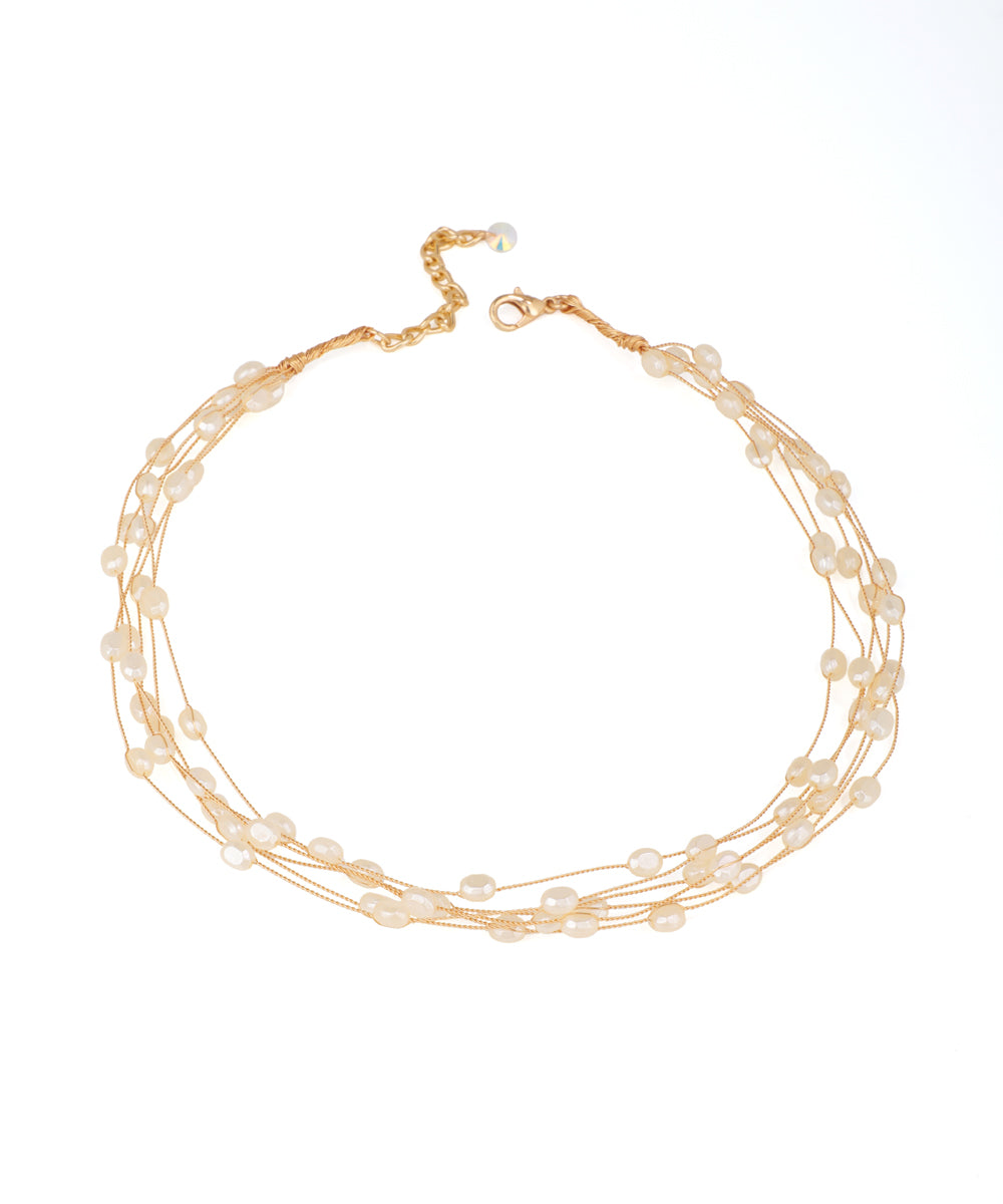 Gold-tone multi-strand necklace with delicate scattered irregular beads