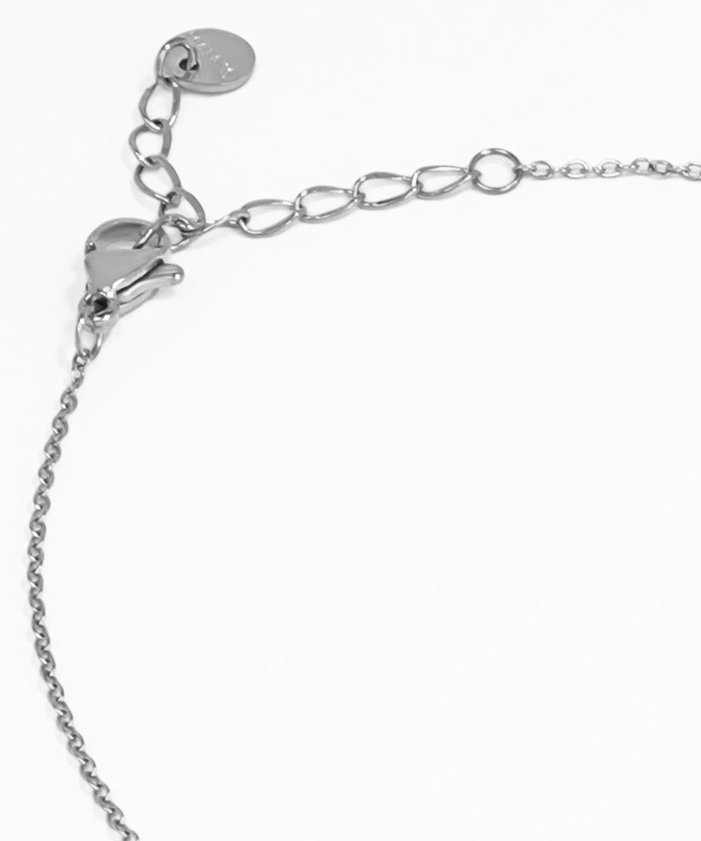 Silver bracelet with a heart charm on a white background