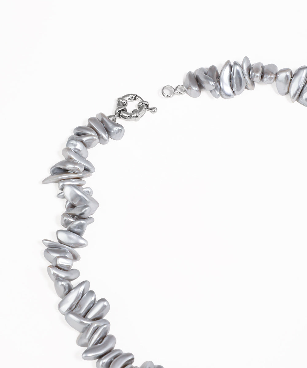 Silver beaded necklace on a white background