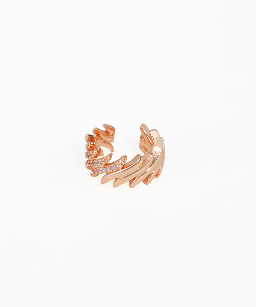 Rose gold ear cuff with intricate design on a white background
