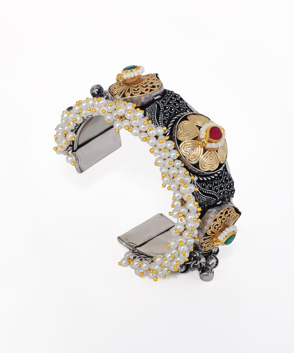 Decorative bracelet with intricate designs on a white background