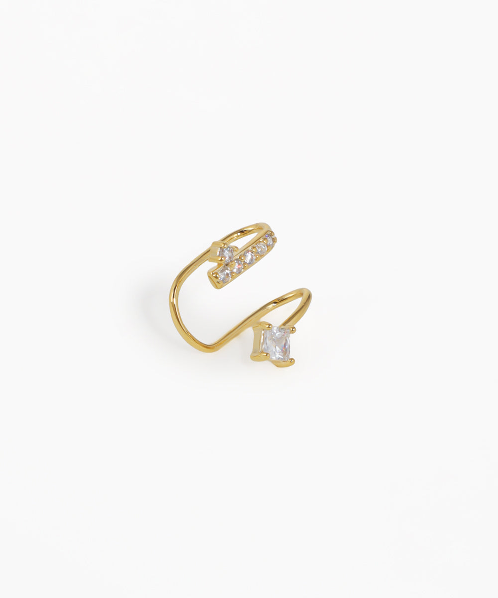 Gold open ring with clear gemstones on a white background