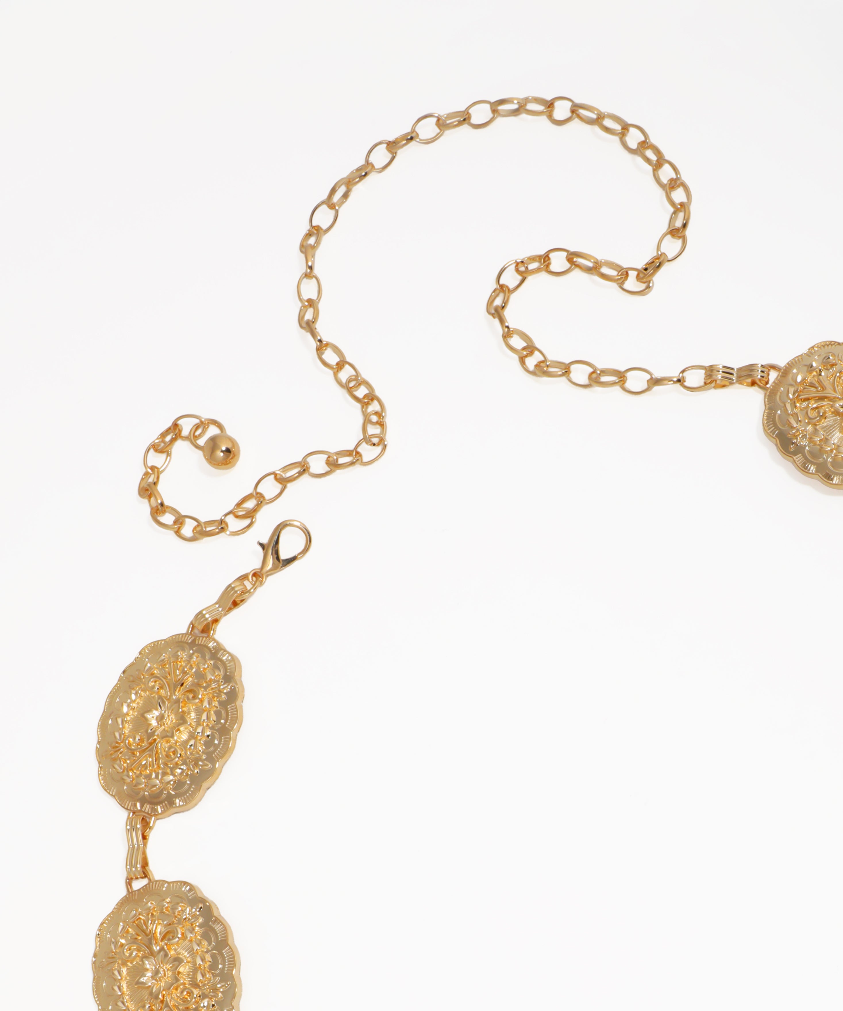 Gold necklace with spherical beads on a white background