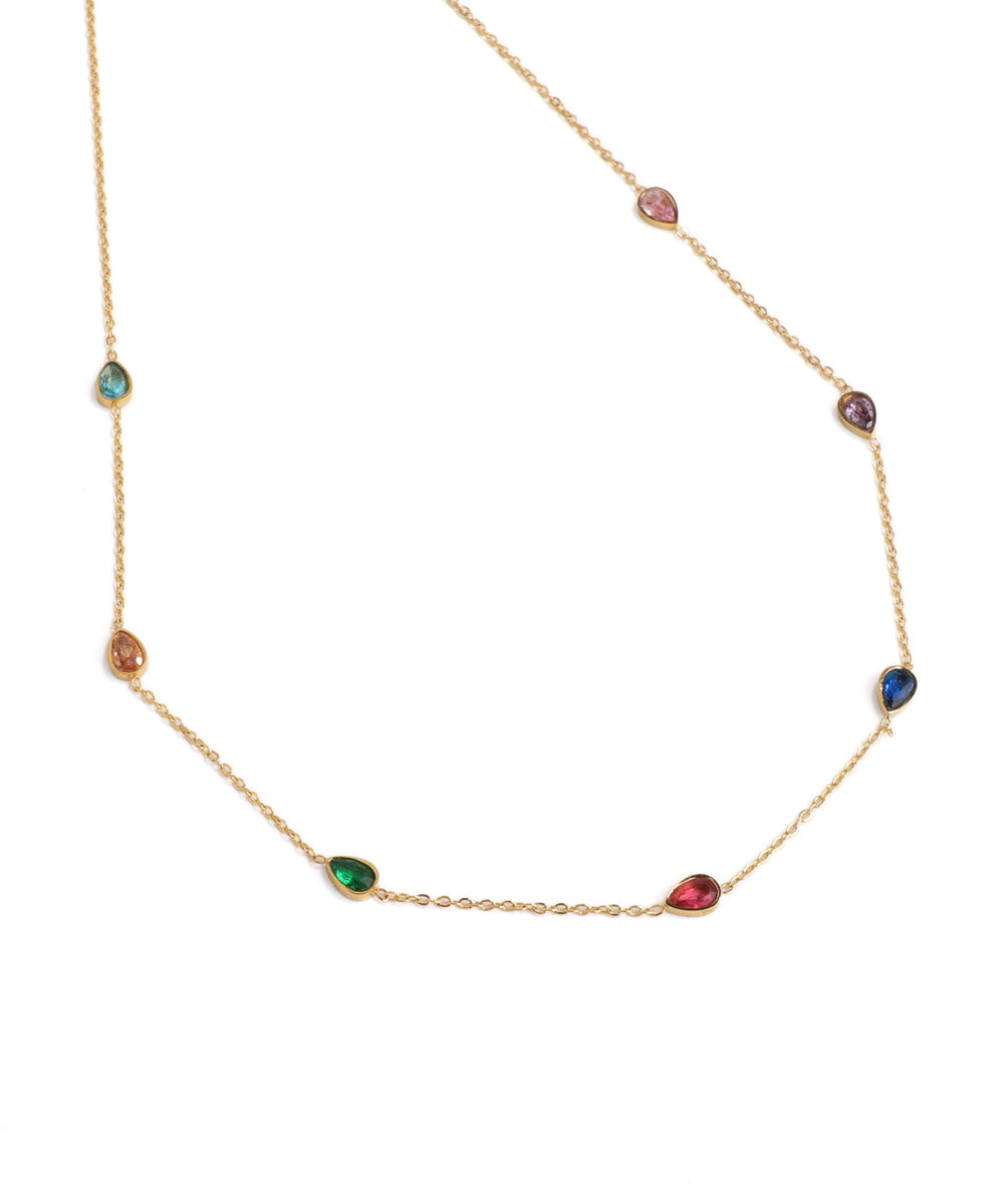 Gold necklace with multicolored gemstones on a white background