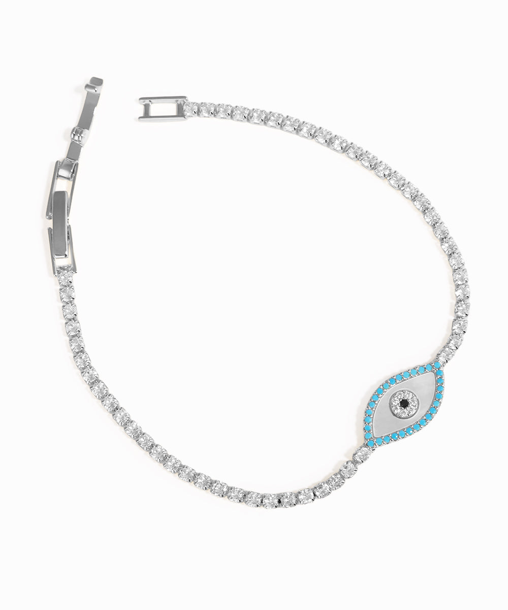 Silver bracelet with a blue evil eye charm on a white background