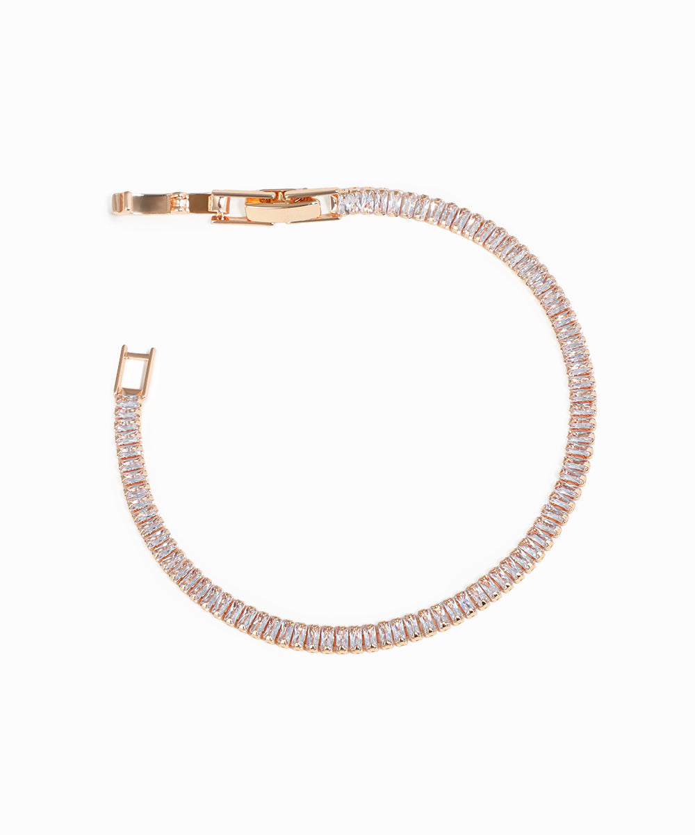 Rose gold bracelet with clear gemstones on a white background