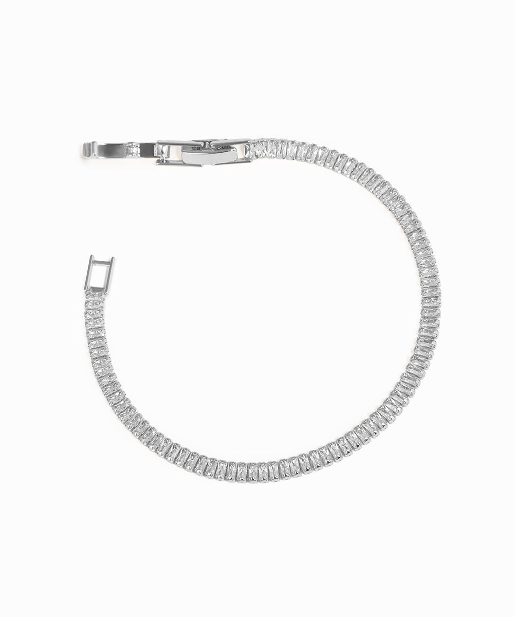 Silver bracelet with clear stones on a white background